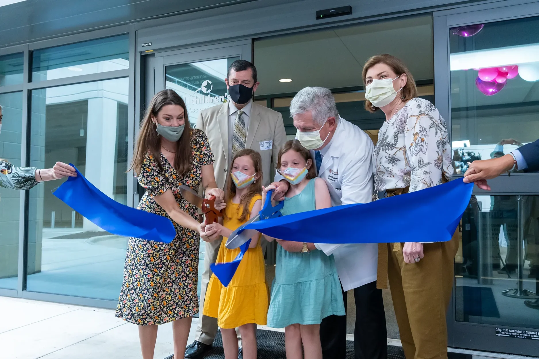 A ribbon cutting in front of the Dell Children's Medical Center.