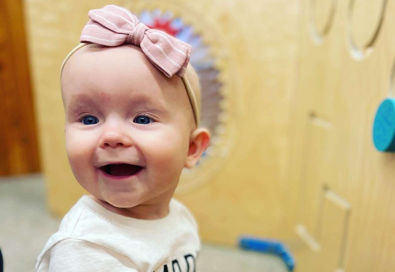 A smiling infant girl.