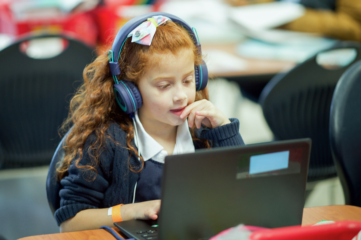 Girl on a laptop wearing headphones