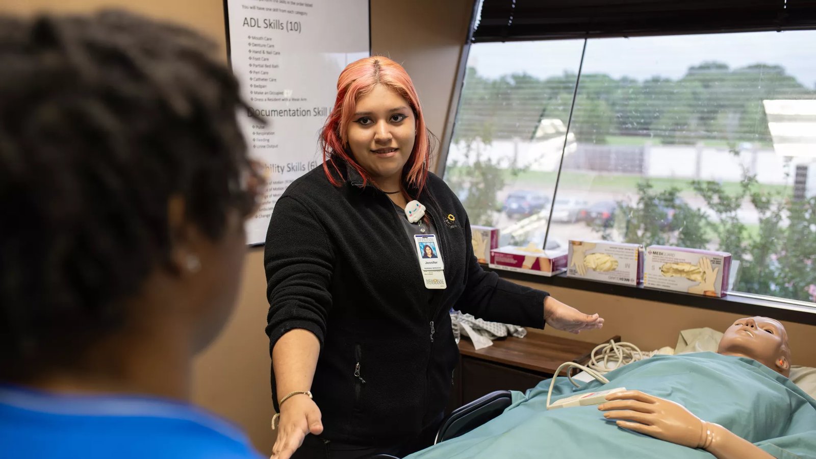 An ACAM student works in a health care setting.