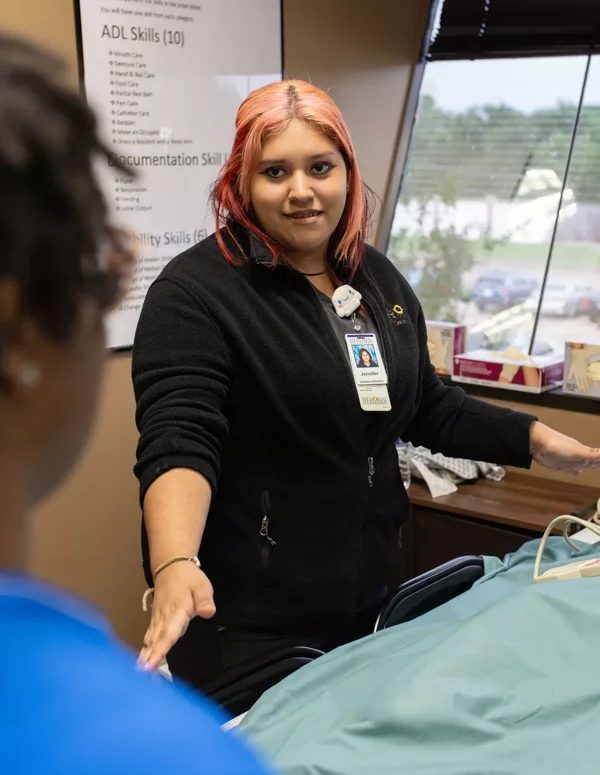 An ACAM student works in a health care setting.