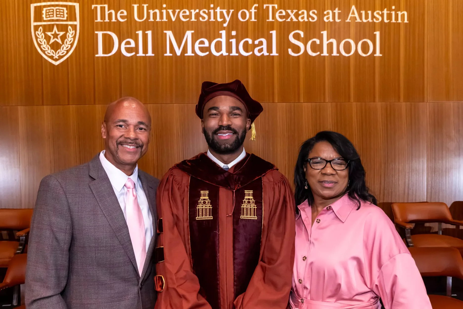 A Dell Medical School graduate poses with his family.