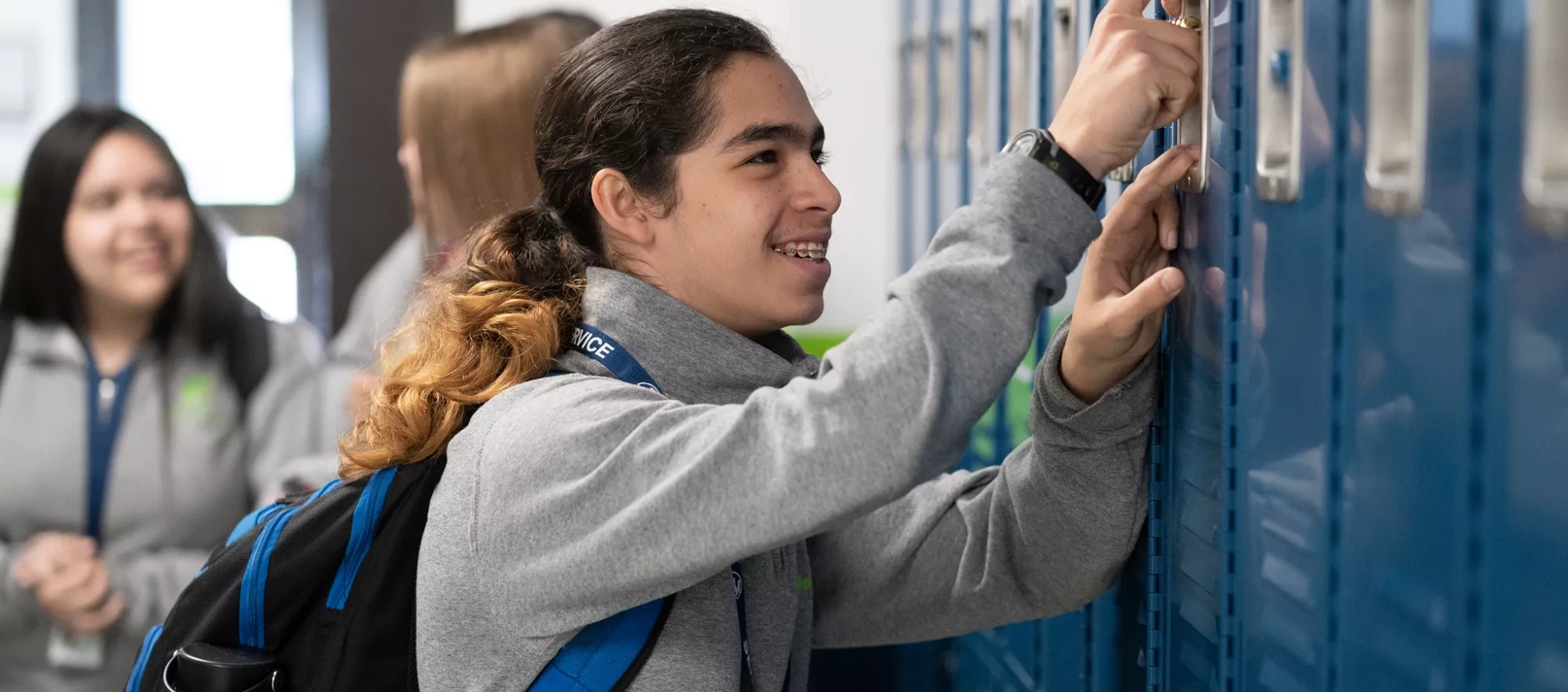 A student opens his locker.