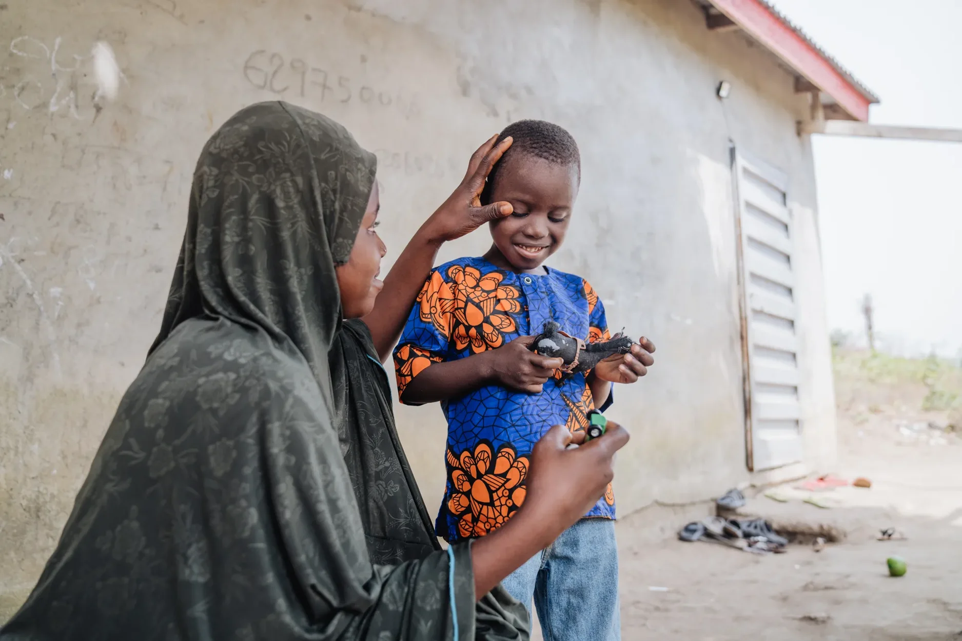 Mamadou's mother, Salematu, worried as her young son struggled with vision, unable to see clearly or walk without stumbling.