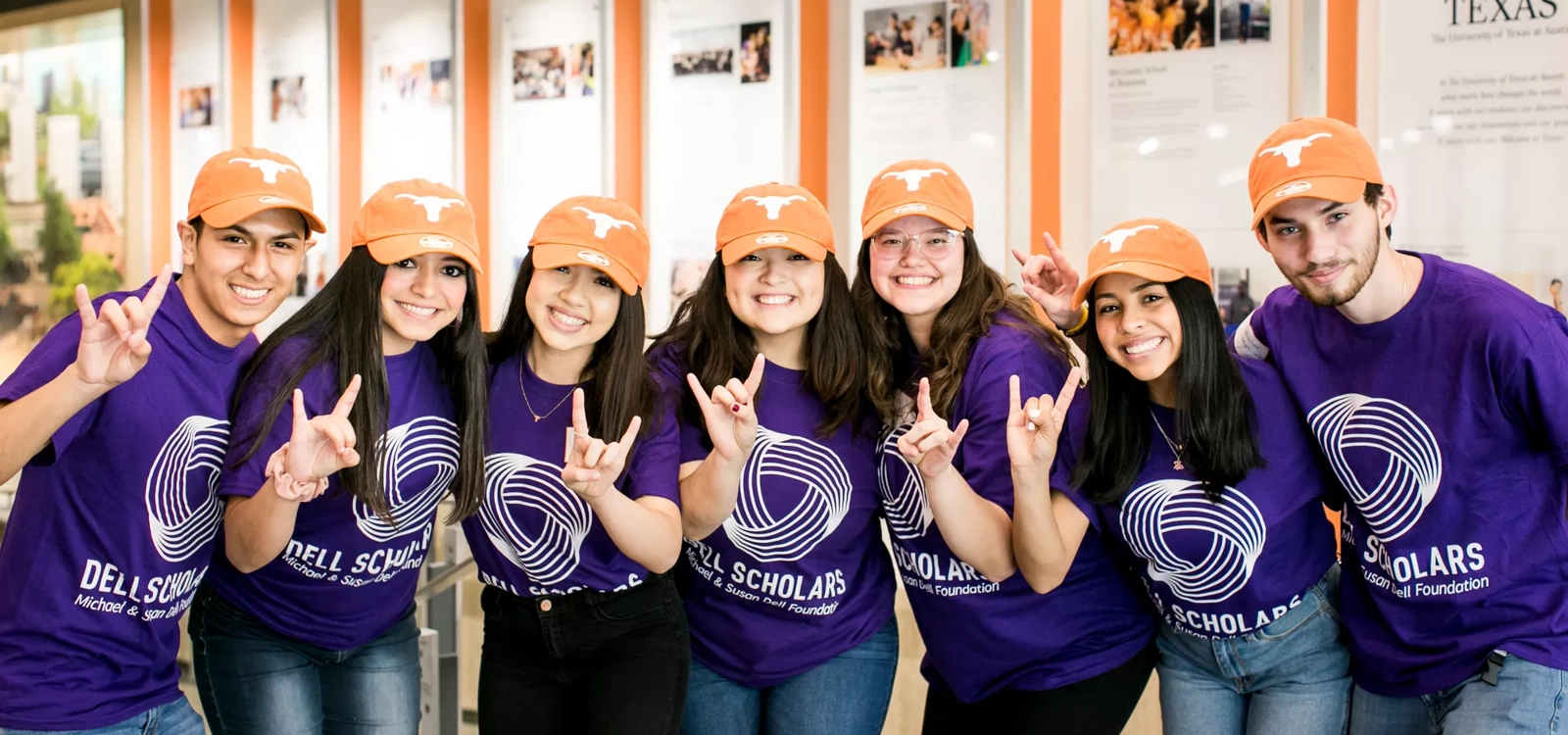 A group of Dell Scholars at UT Austin making the "Hook 'Em" Longhorns sign with their hands.