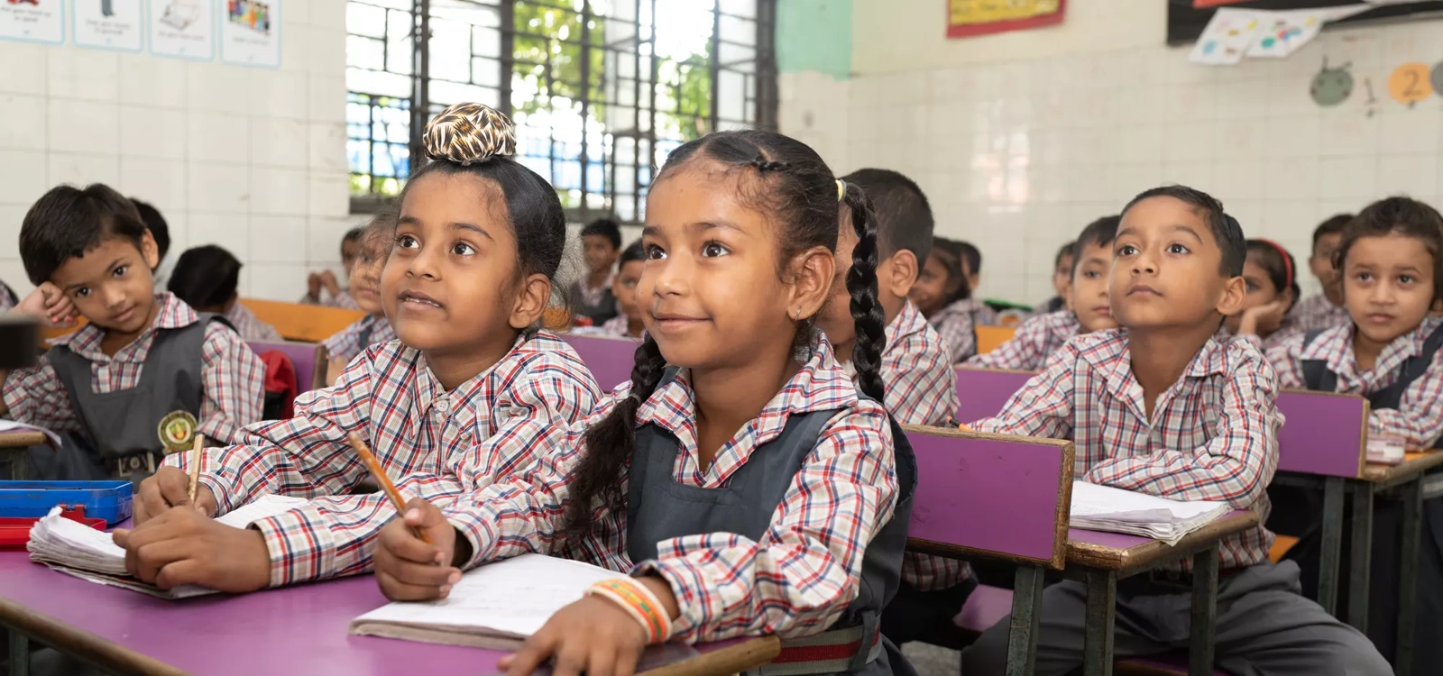 A group of Indian school children in a classroom.