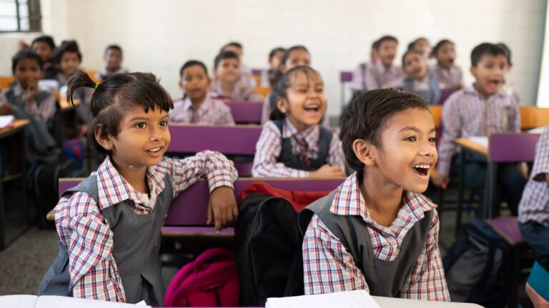 Students smiling in a classroom