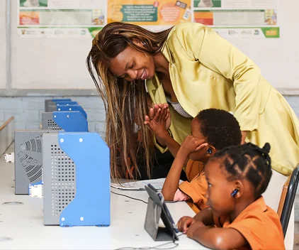 A teacher high fives one of her students.