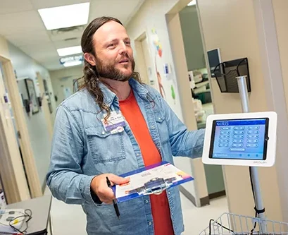 A community healthcare work stands in the hallway of a clinic.