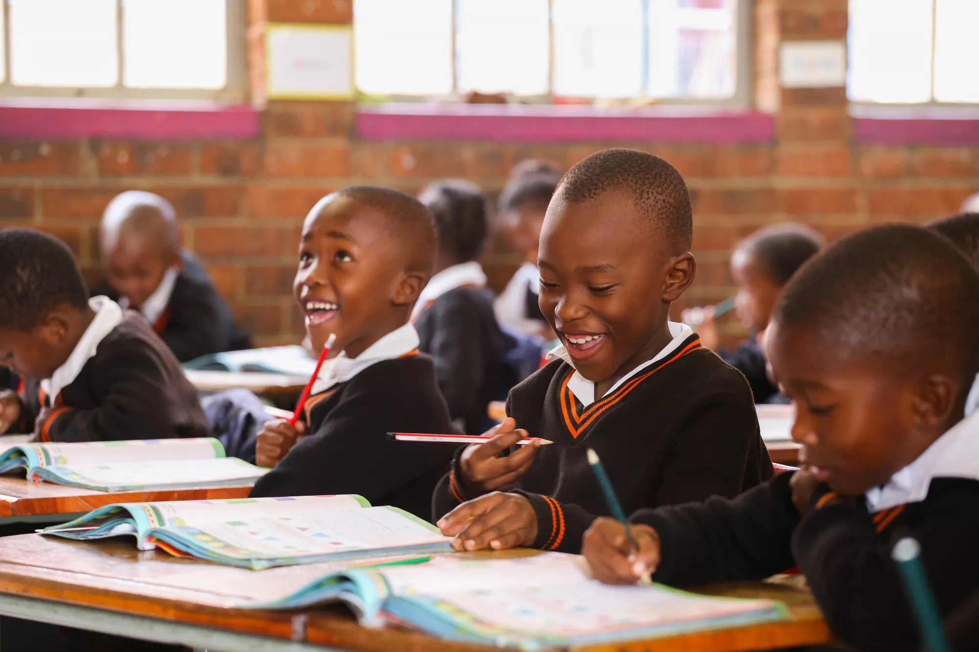 Smiling students in a classroom.