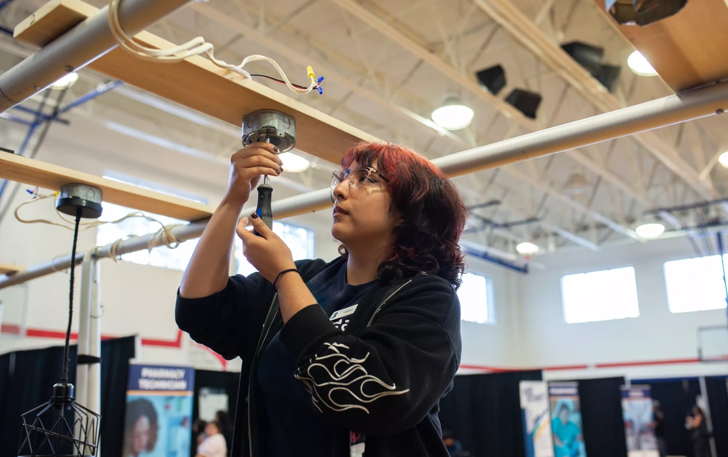 A facilitator does electrical work at BridgeYear's Career Test Drive event held at Davis High School in North Houston.