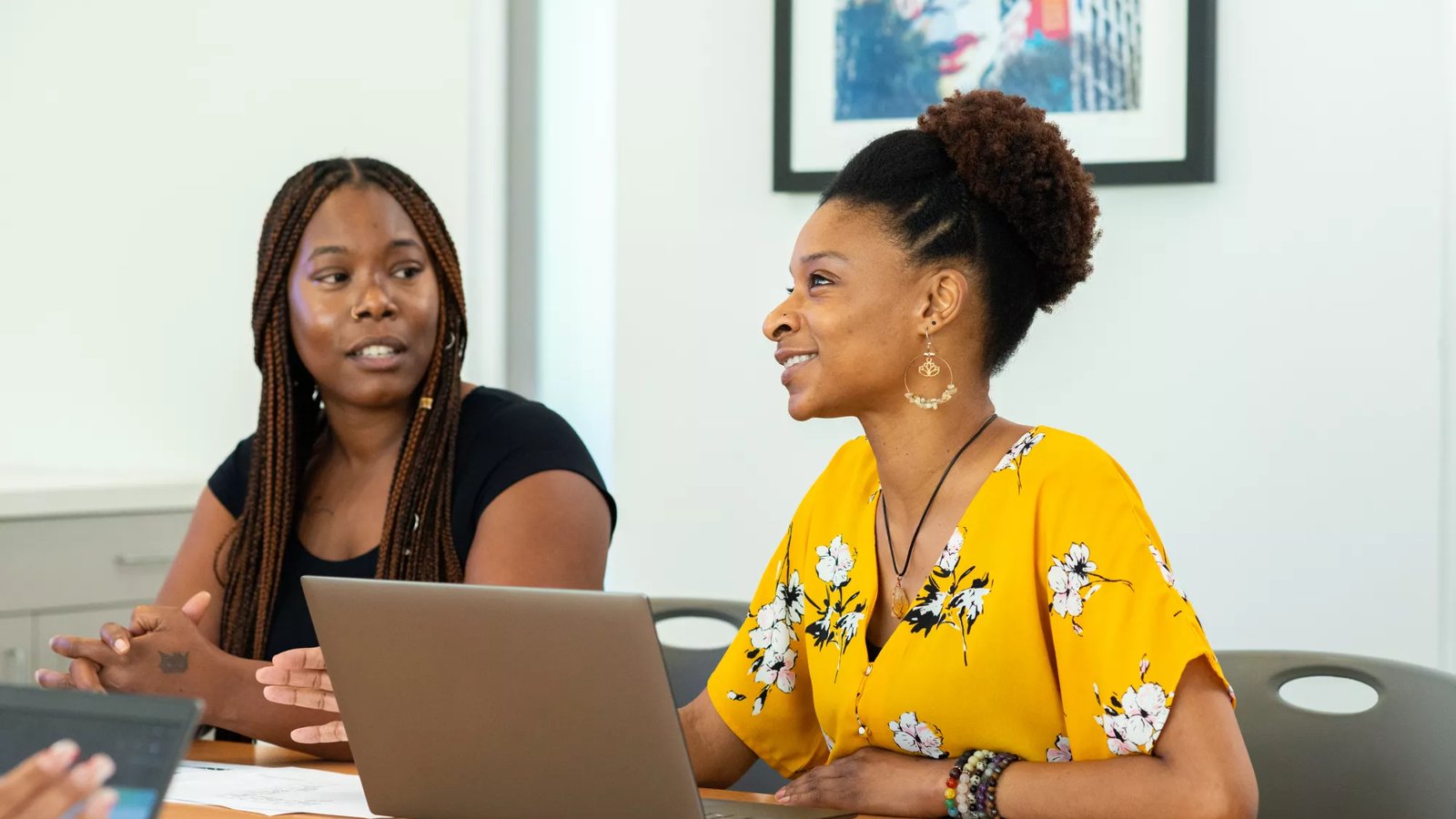 A Lifeworks client sits at a table with a staff member.