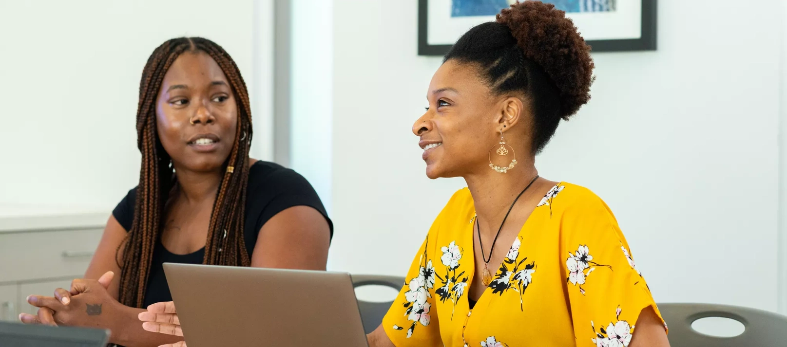 A Lifeworks client sits at a table with a staff member.