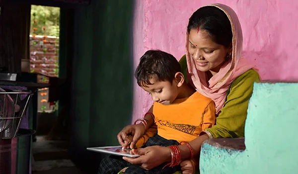 A woman and a child look at a game together.