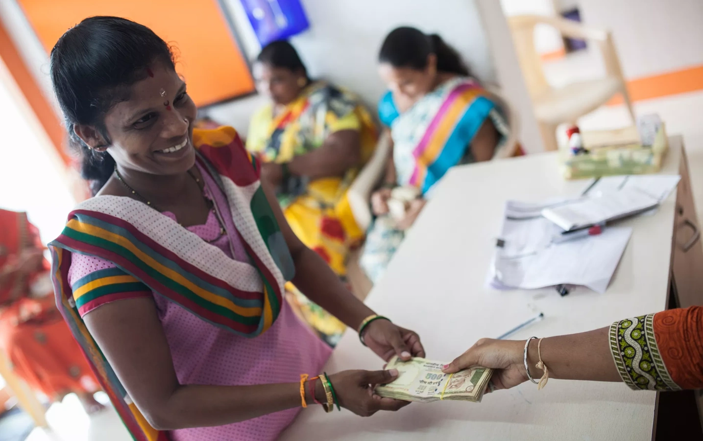 A woman receives cash.