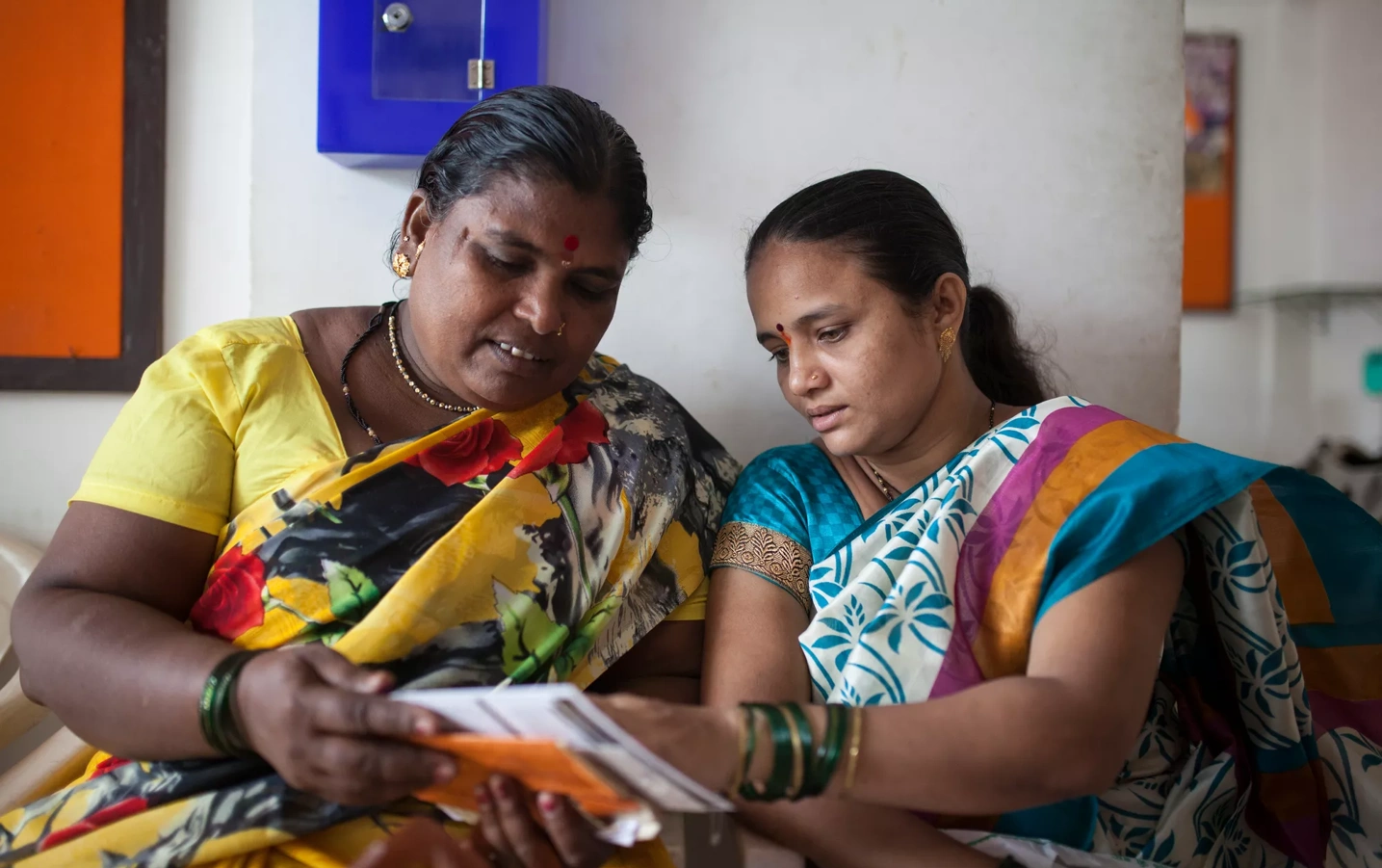 Two women opening mail.