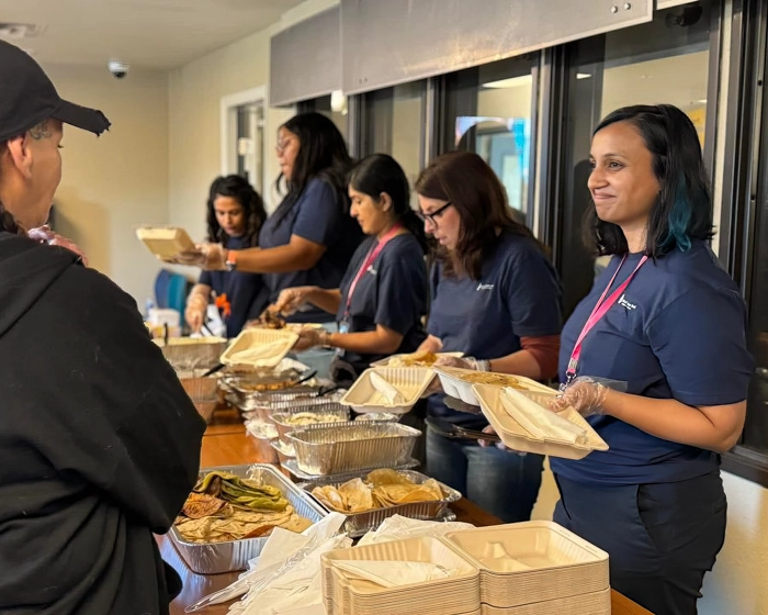 Dell Foundation staff members serving meals.